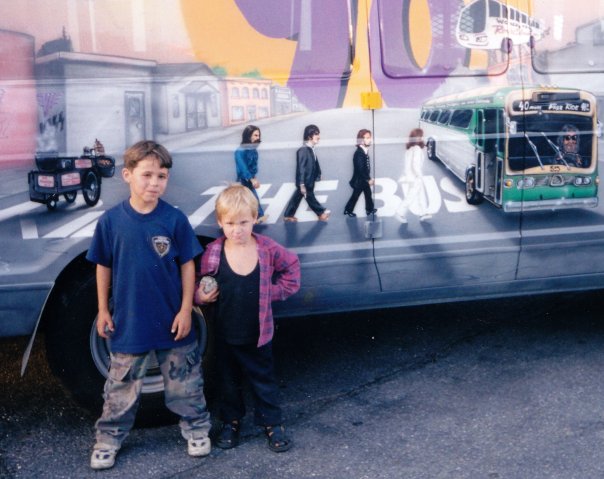 Zachary and I as little kids standing proudly in front of a city bus our dad had airbrushed.