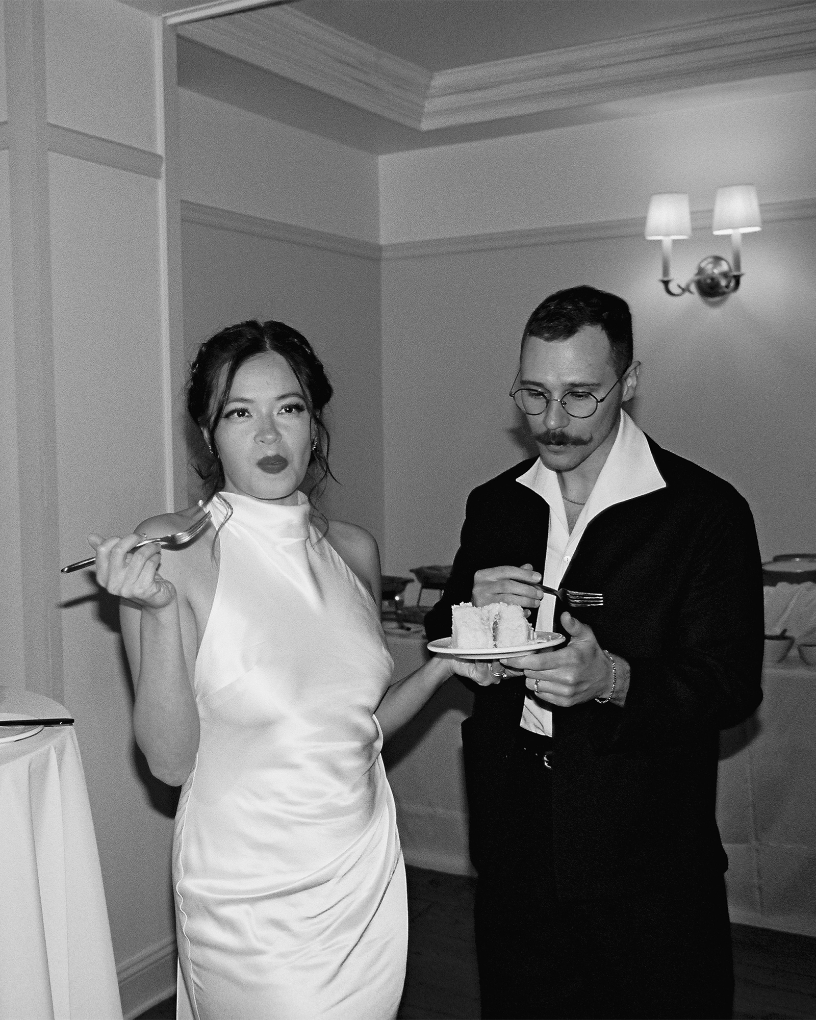 Kara and I nonchalantly enjoying some of our wedding cake.